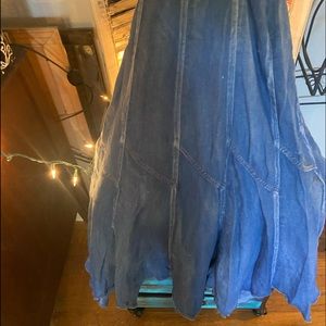 Long blue jean shirt . Frayed on the bottom .